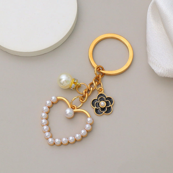 Elegant women's bag charm with heart & flower motif, perfect for key organization.