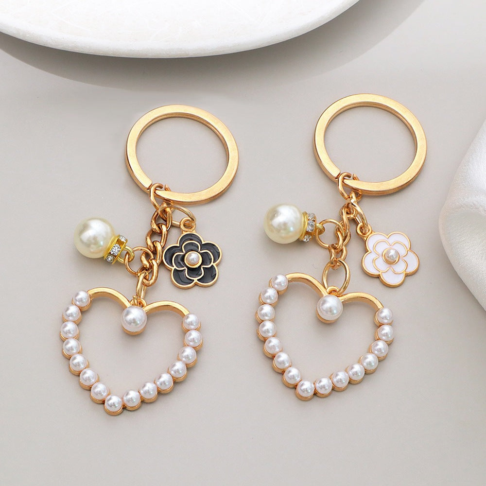 Rose gold heart and flower bag charm with sparkling rhinestones for women.