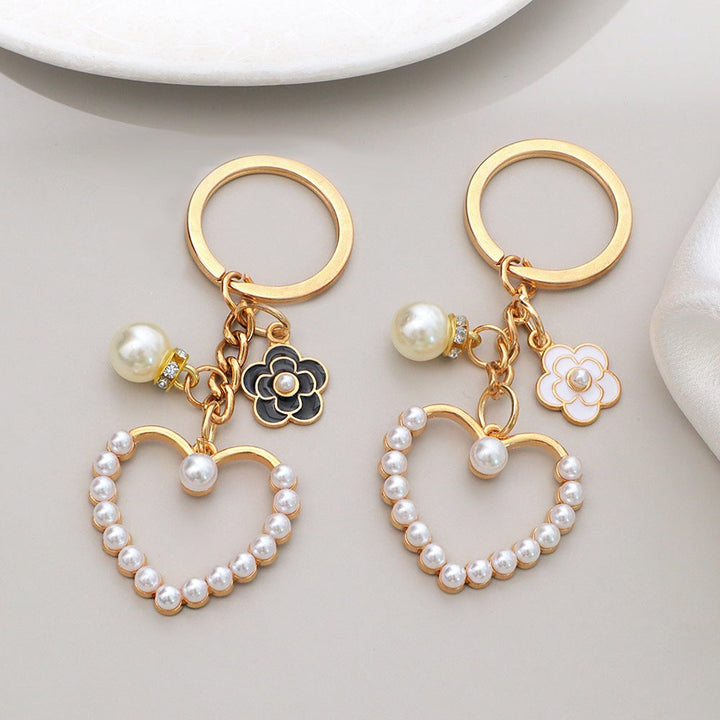 Rose gold heart and flower bag charm with sparkling rhinestones for women.