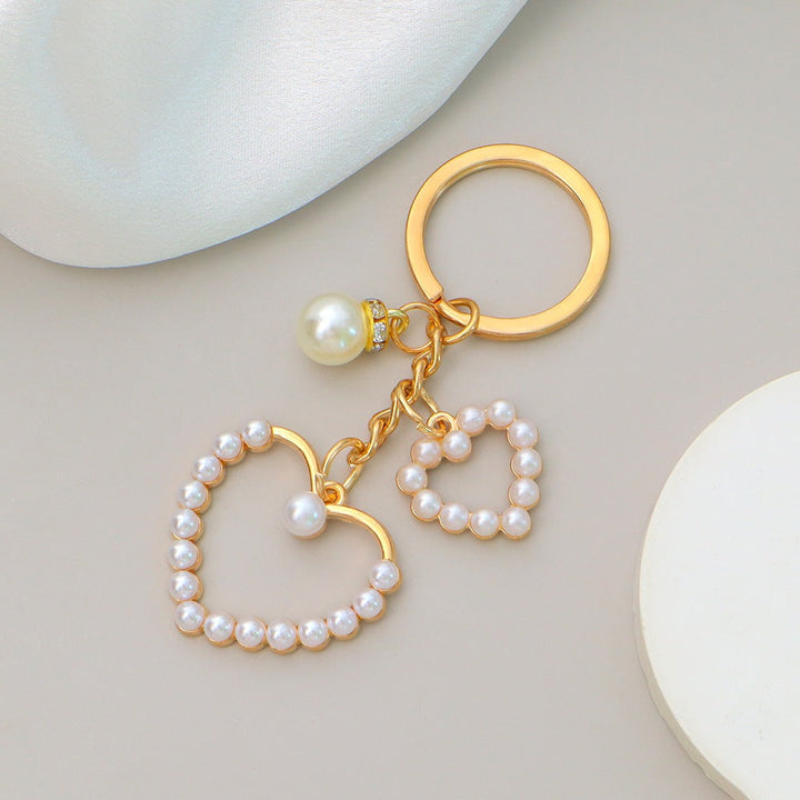 Delicate flower and heart design keychain charm, an elegant bag accessory for women.