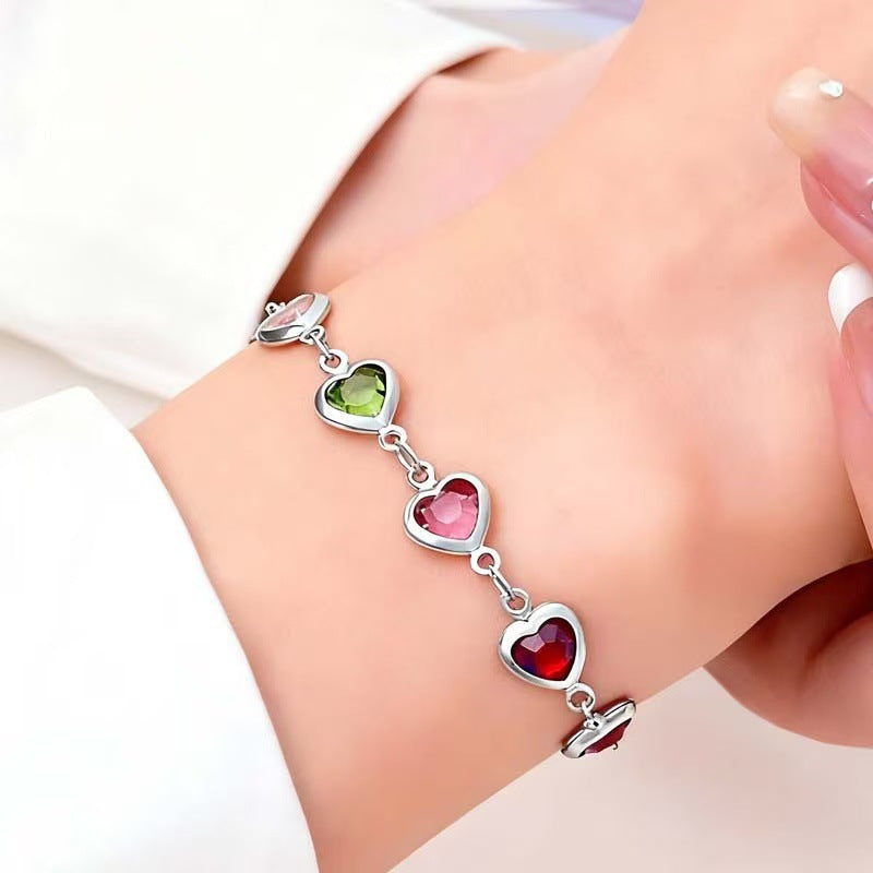 High-quality craftsmanship detail of a women's heart charm with a vibrant gemstone, part of elegant jewelry.