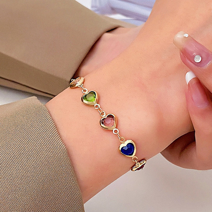 Chic women's ankle adorned with an adjustable heart gemstone anklet, a stylish fashion accessory.