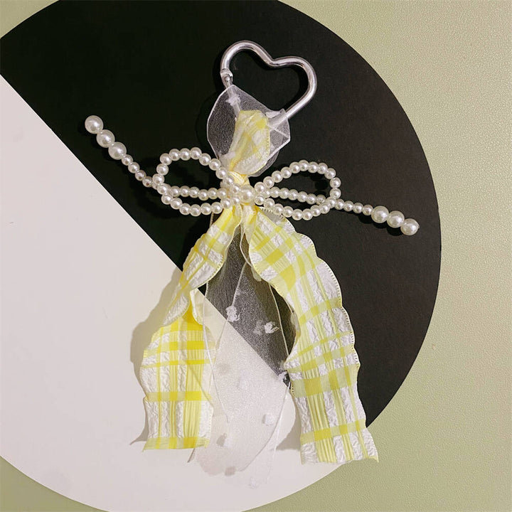 Chic heart keychain for women, elegant pearl & ribbon charm, a stylish accessory for bags, purses & gifts.