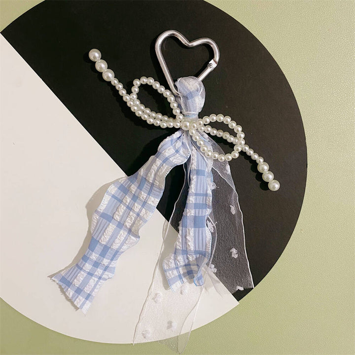 Women's fashion heart keychain, an elegant charm with pearl & ribbon for purses and bags, a stylish accessory.