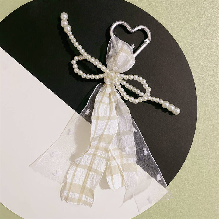 Stylish gift: women's elegant heart keychain with pearl & ribbon, perfect purse or bag charm accessory.