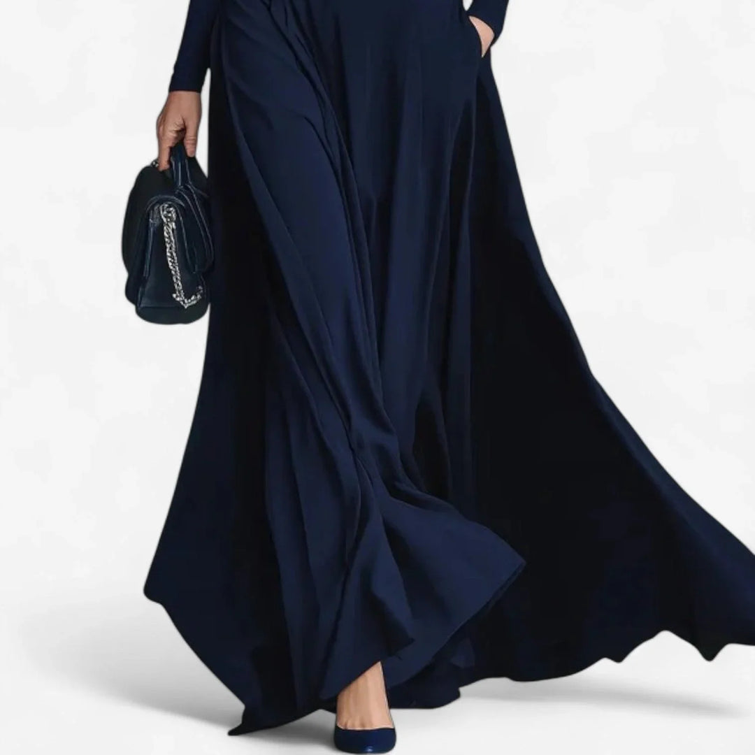 Stylish blue women's long sleeve maxi dress featuring a high neck, A-line skirt, and a flattering belted waist.