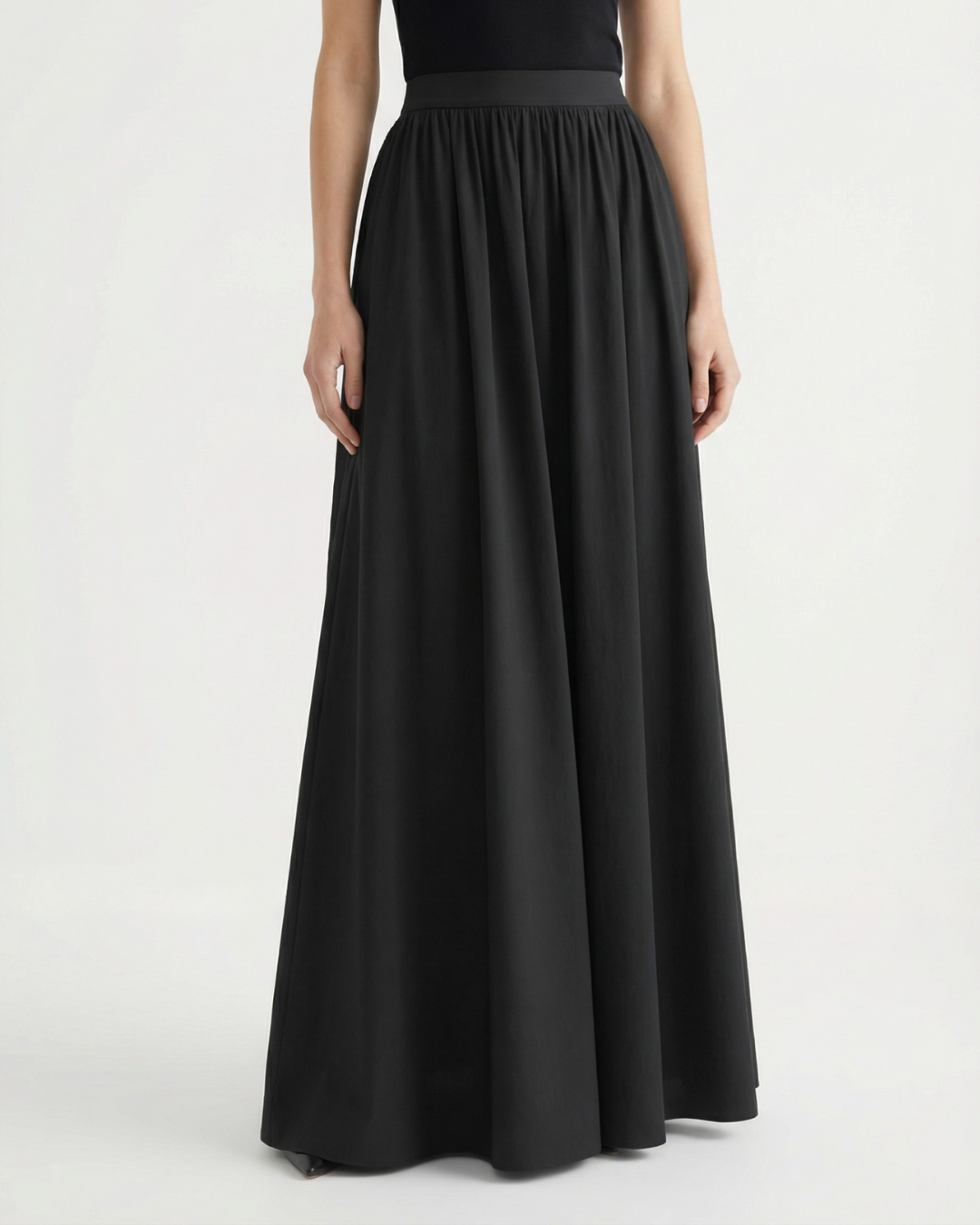 Black elegant high-waist maxi skirt, flowing fabric for office wear or chic casual outfits.