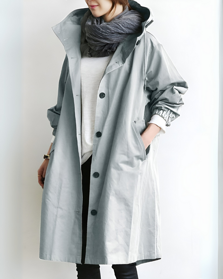 Elegant women's hooded trench coat. Classic long sleeve, single-breasted outerwear for timeless autumn/winter fashion & warmth.