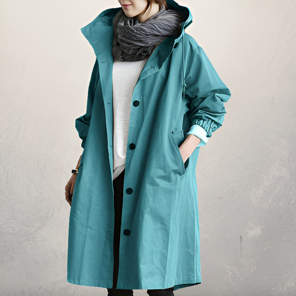 Women's elegant hooded trench coat. Loose fit, long sleeve, single-breasted. Classic outerwear for warmth & timeless style.