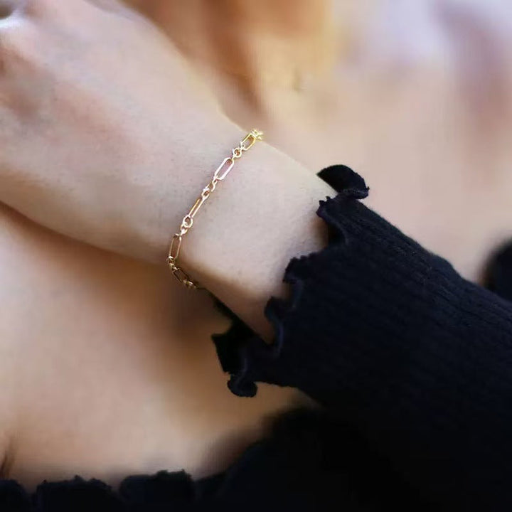 Elegant women's interlocking link bracelet in a radiant gold finish, a chic fashion accessory.