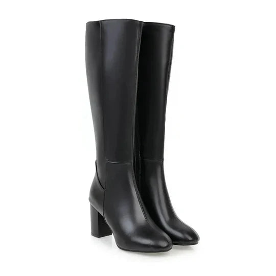 New women's heeled knee-high boots with a sleek zipper, offering chic style for elegant fall and winter looks.