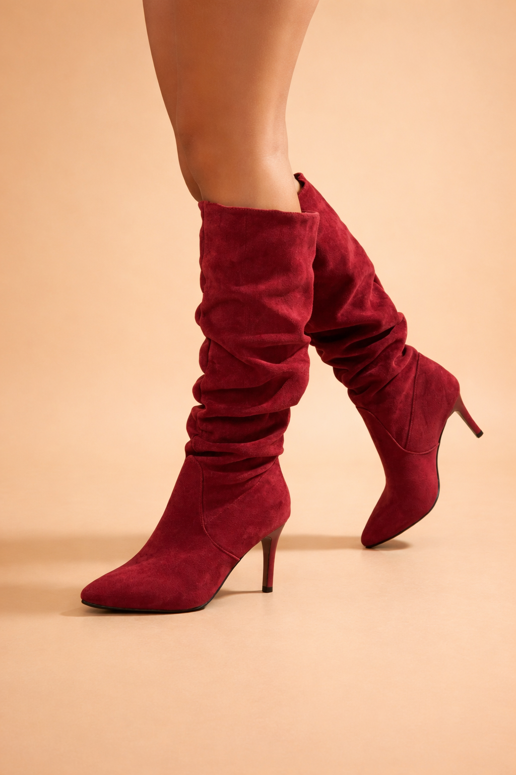 Stylish women's high-heeled knee-high slouch boots, an elegant fashion statement with a pointed toe.