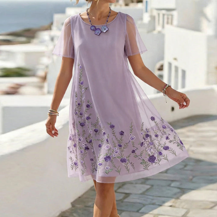 Elegant women's lavender floral embroidered midi dress with sheer details, perfect for wedding guests or special occasions.