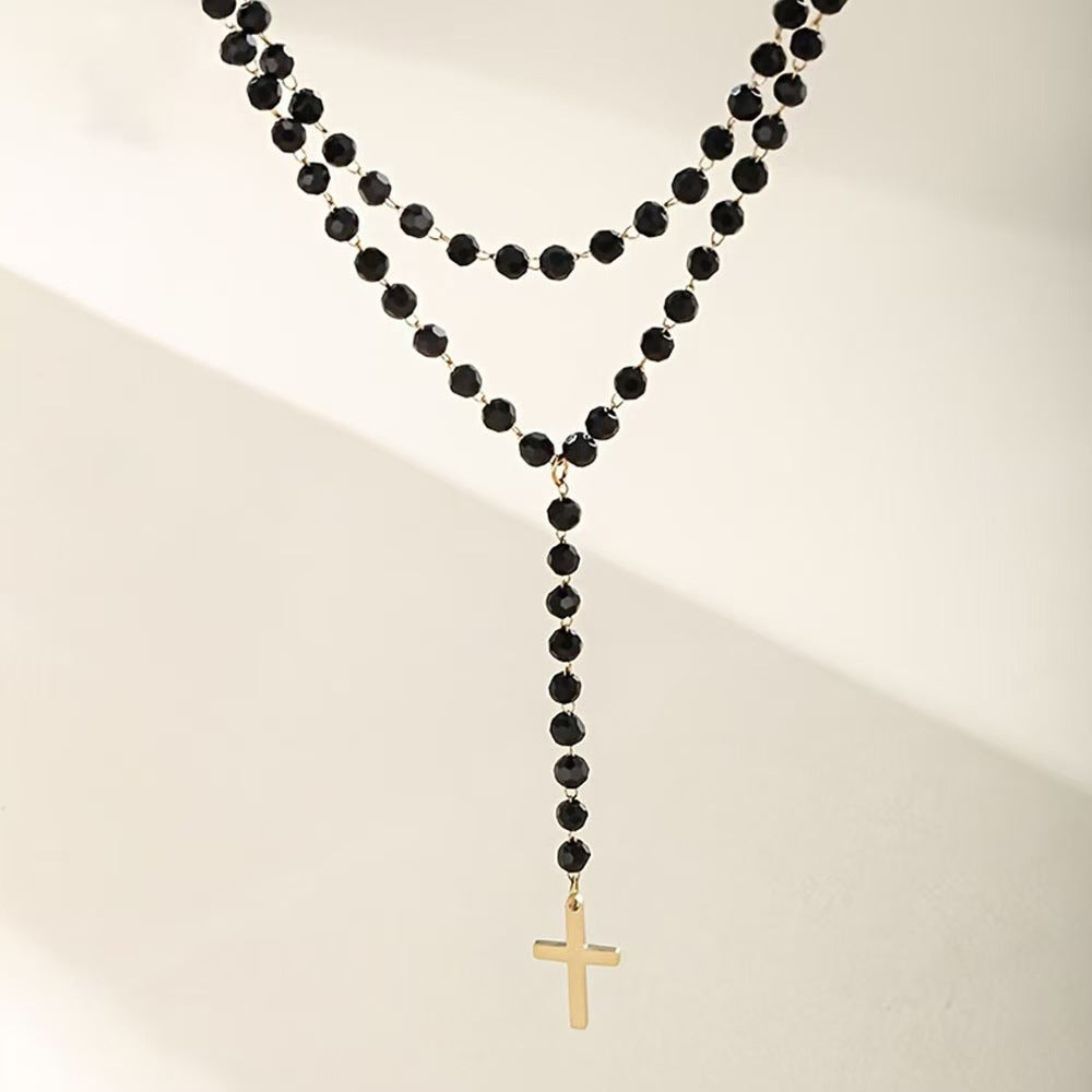 Stylish women's layered necklace with intricate beaded chains and elegant cross & star pendants. Spiritual fashion.