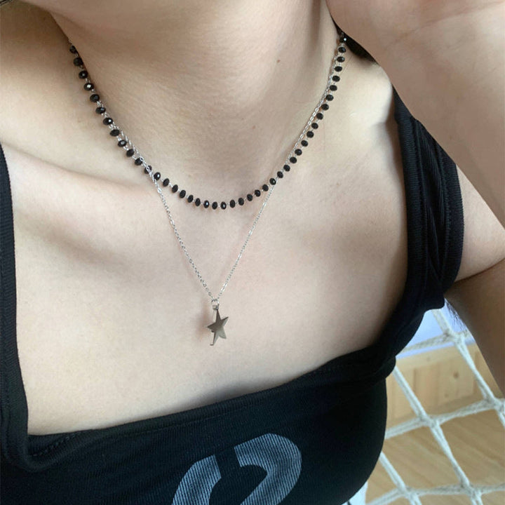 Delicate women's layered necklace featuring multiple beaded chains, a shimmering cross, and a charming star pendant.