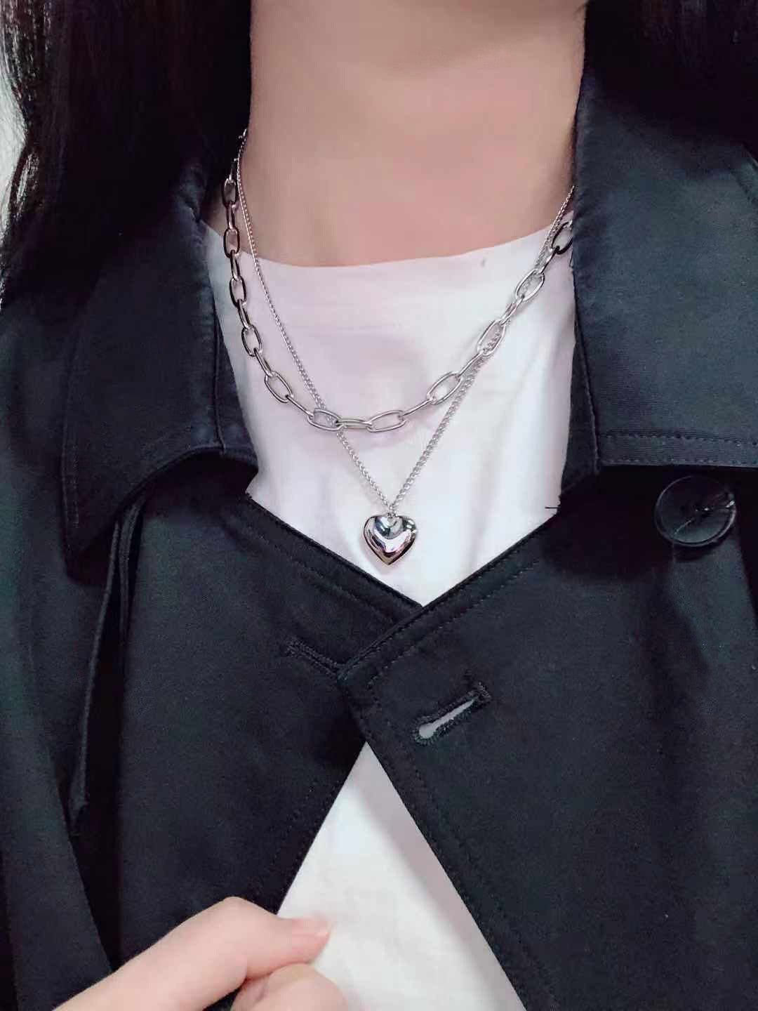 Fashionable layered heart necklace for women, combining multiple chains for an elegant, modern look.
