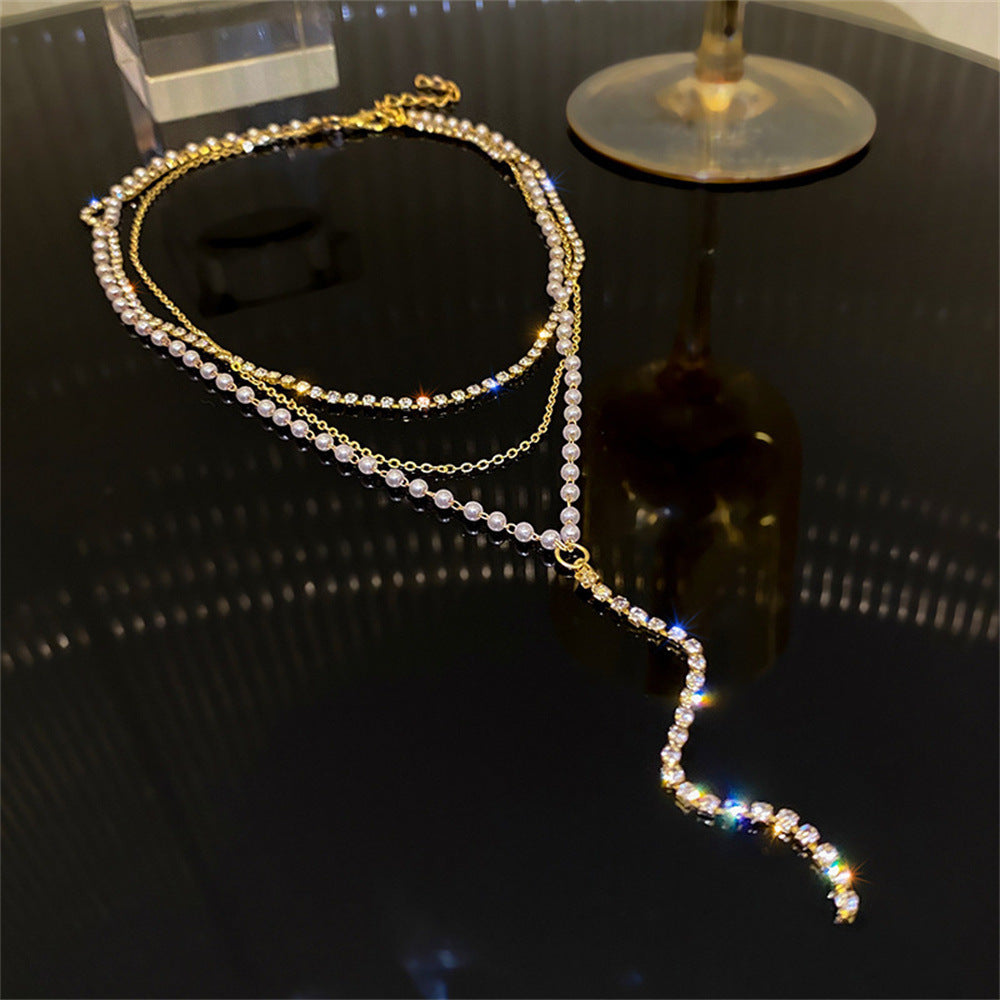 Beautiful layered pearl and crystal necklace. This elegant women's jewelry features multiple strands for a chic look.