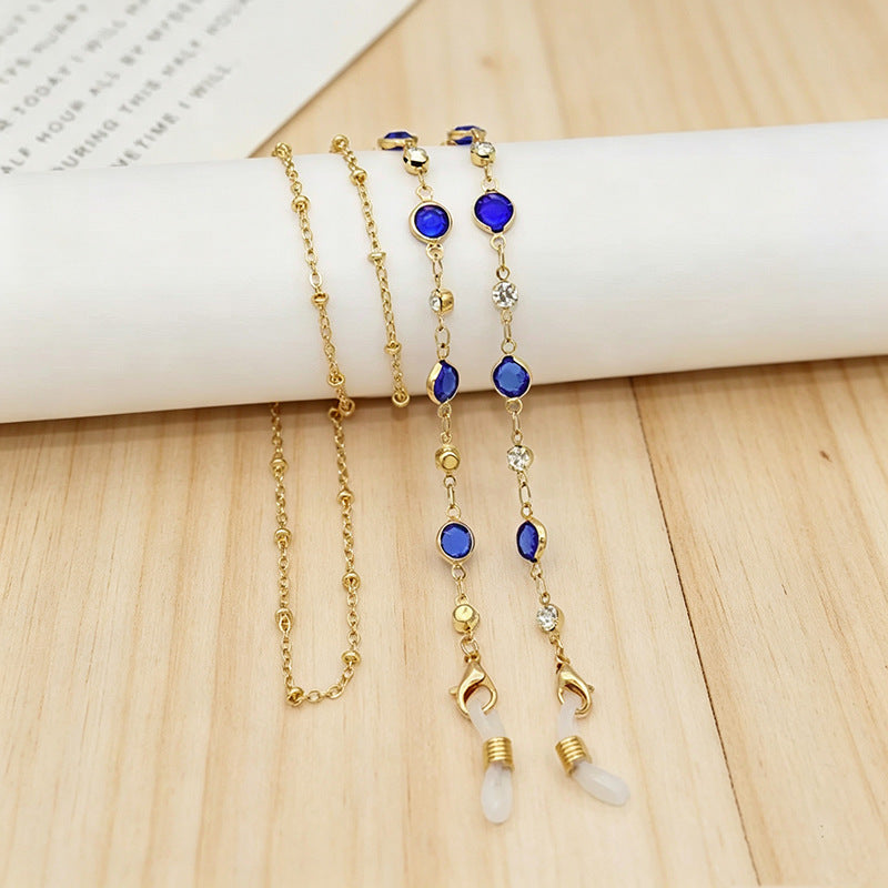 Ornate gold tone layered necklace adorned with shimmering colorful crystals, elegant women's jewelry.