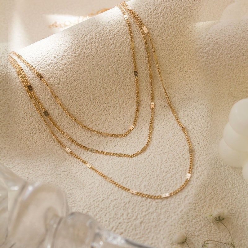 Delicate women's layered silver-tone chain necklace, an elegant fashion statement.