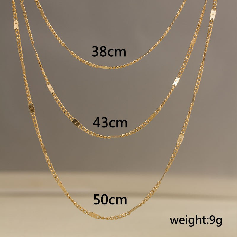 Women's delicate layered gold chain necklace, a sleek and elegant fashion accessory.