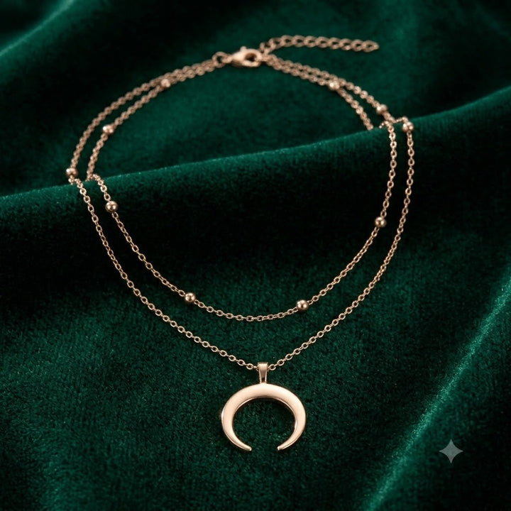 Exquisite gold-plated layered necklace with a sparkling crescent moon pendant. Delicate and elegant women's jewelry.