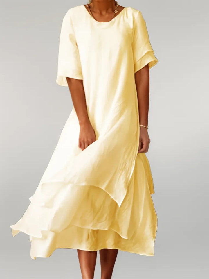 Pink layered midi dress for women. Versatile and elegant with a flowy silhouette, ideal for any event.