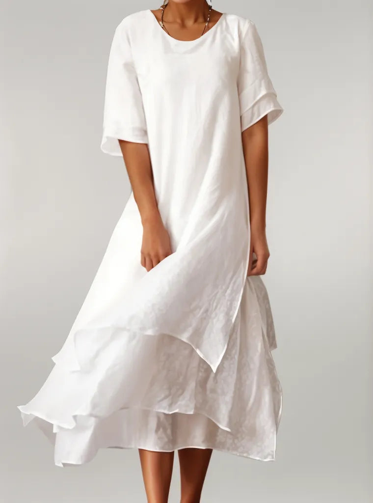 White women's midi dress with elegant layered design. Flowy summer style, perfect for versatile wear.