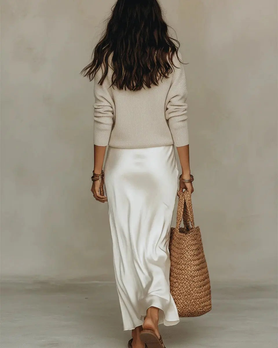 Elegant women's layered midi dress, a sophisticated two-piece set with a satin slip and knit jumper.