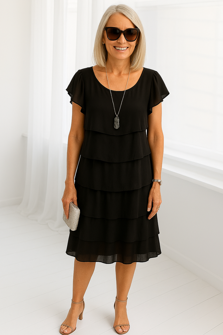 Sophisticated women's layered midi dress. Elegant short sleeve design offers comfortable, effortless style for any special occasion.