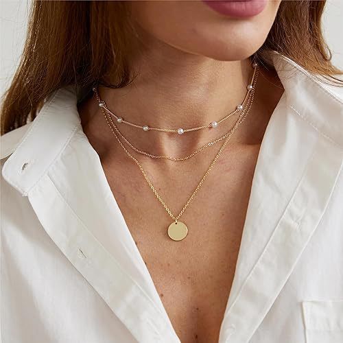 Women's chic layered pearl & gold chain necklace, a fashionable jewelry accessory.