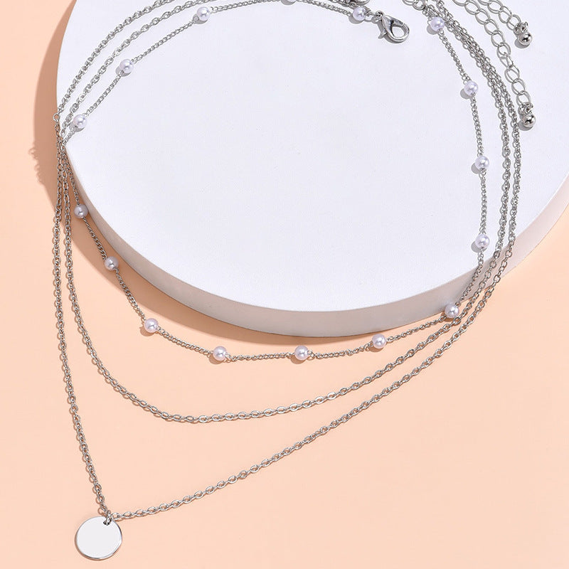 Stylish women's elegant layered necklace featuring pearls & gold-tone chains, perfect accessory.