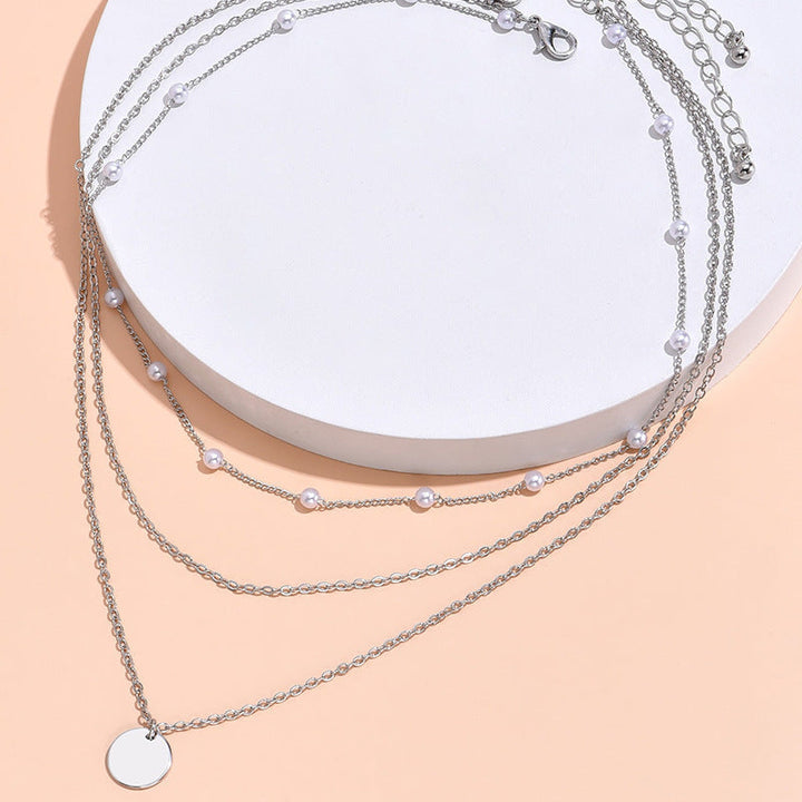 Stylish women's elegant layered necklace featuring pearls & gold-tone chains, perfect accessory.
