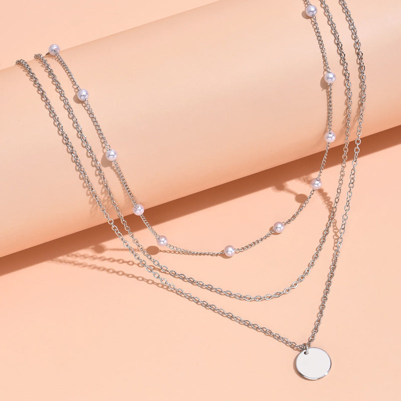 Beautiful women's layered pearl & chain necklace, an elegant gold accessory for any outfit.