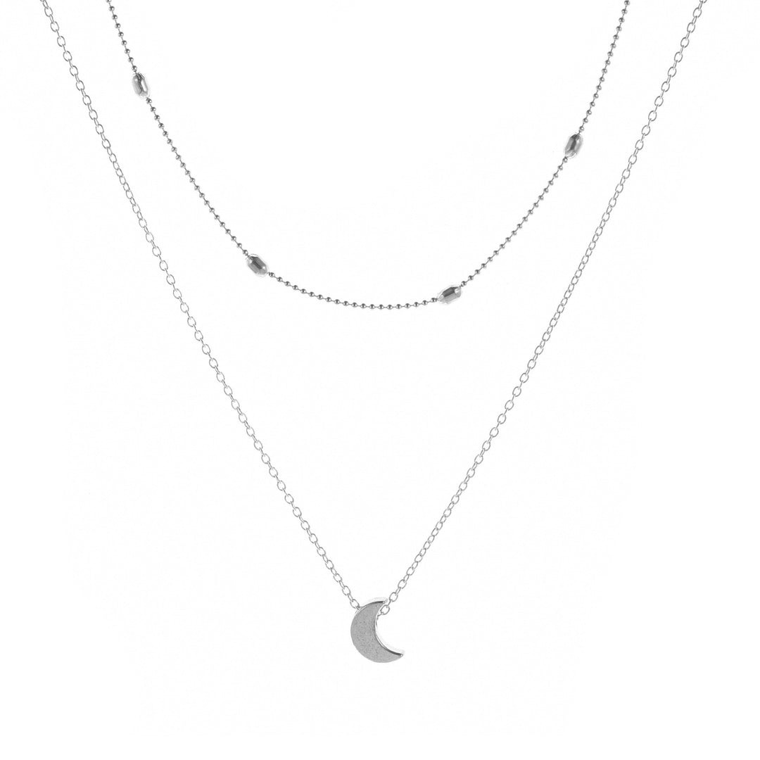Elegant delicate layered necklace featuring moon, star, and heart charms for women. Gold-tone jewelry.