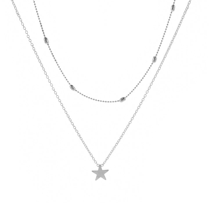 Modern women's layered charm necklace with a heart pendant, offering an elegant and versatile look.