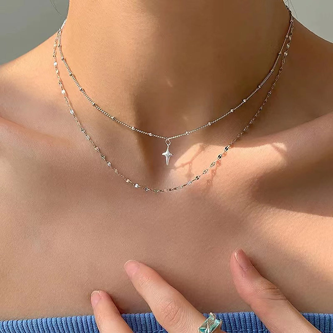 Elegant women's layered necklace with delicate star & dot charms, a perfect fashion jewelry gift for her.