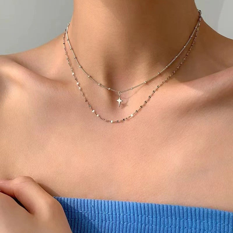 Adjustable women's layered star & dot charm necklace, an elegant accessory for everyday and special occasions.