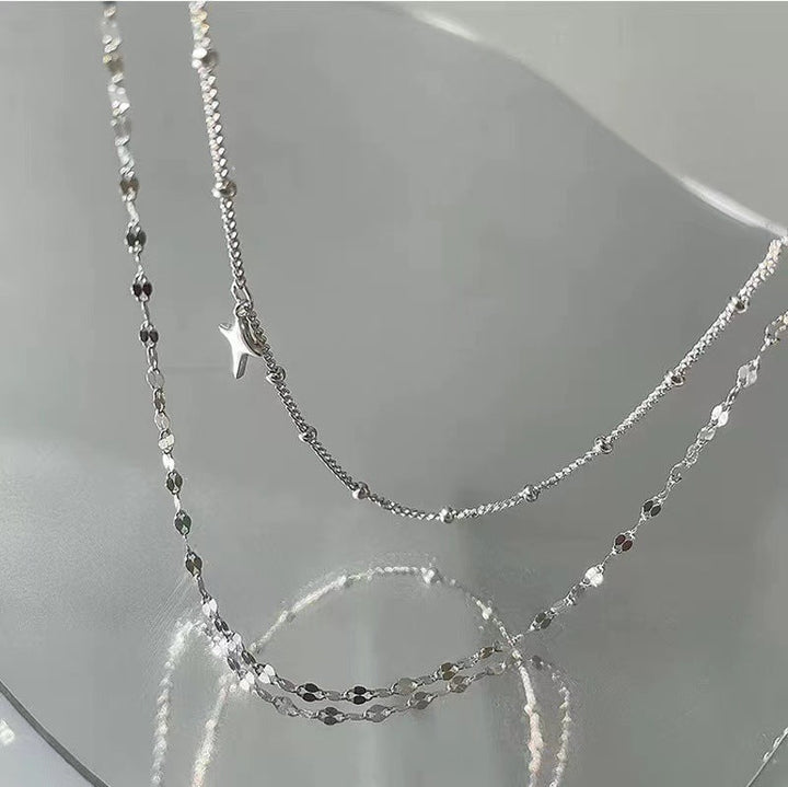 Chic women's layered necklace featuring multiple star charms and subtle dot detailing for a modern look.