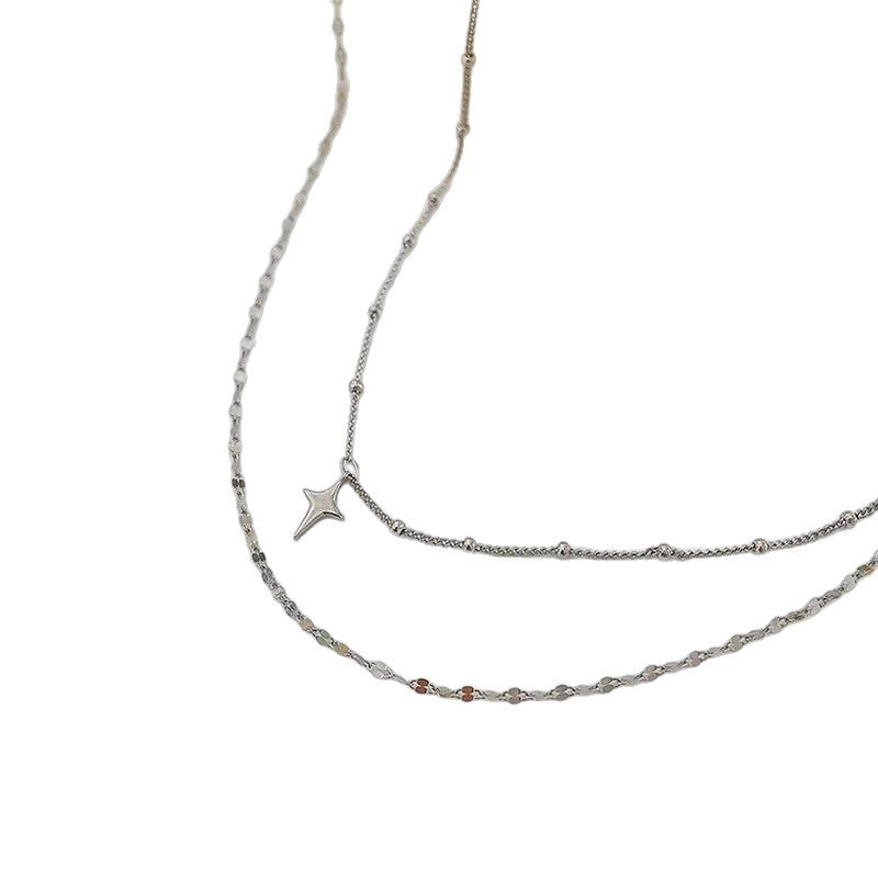 Delicate women's layered necklace, showcasing celestial star and tiny dot charms, ideal for any fashion ensemble.
