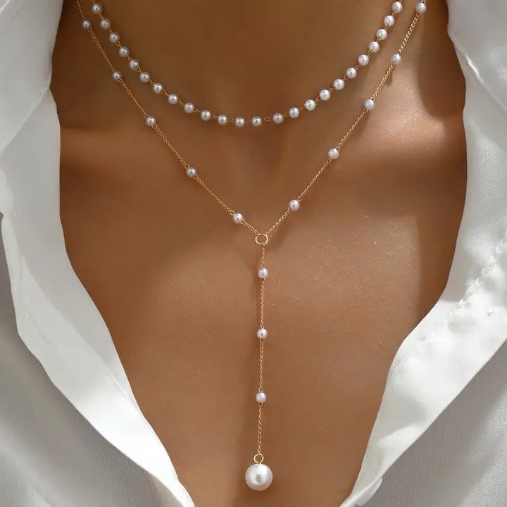 Fashionable layered pearl and gold chain necklace for women, an elegant statement gift idea.