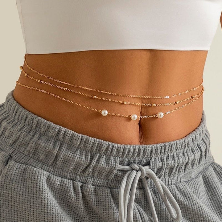 Elegant women's layered pearl necklace featuring multiple strands of white beads & a gold clasp. Perfect fashion accessory.