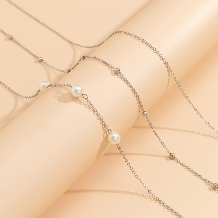 Stunning layered pearl necklace, multi-strand design with lustrous white pearls & delicate gold chains. Elegant gift.