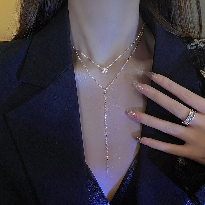 Chic women's layered charm necklace. An elegant gold-tone pendant piece, ideal as a gift for her.