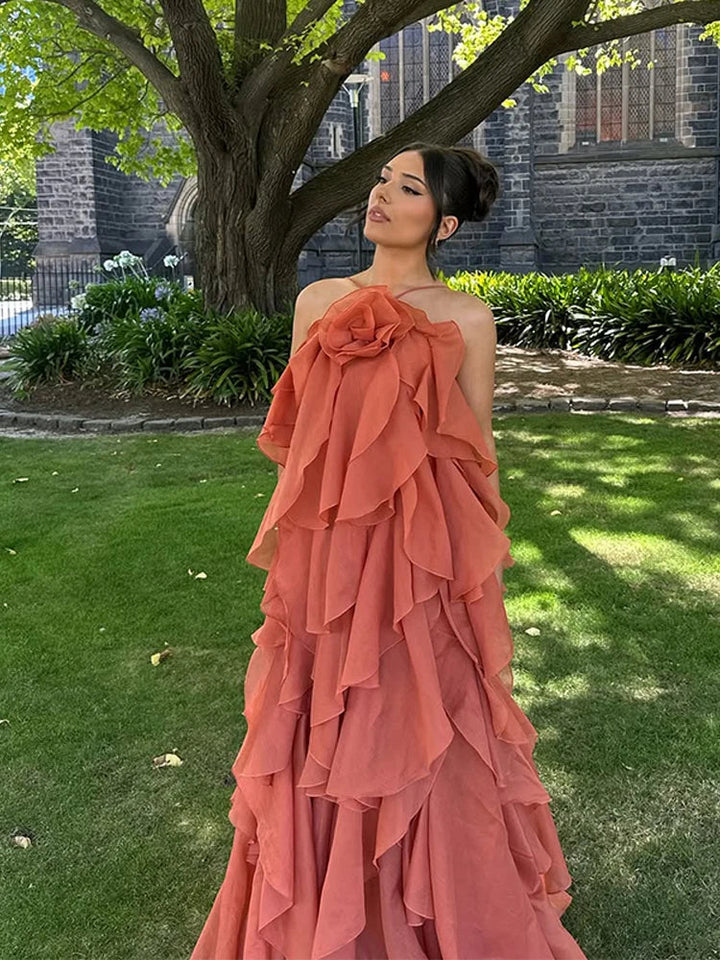 Stylish women's layered ruffle maxi dress featuring a beautiful floral pattern, great for elegant summer fashion.