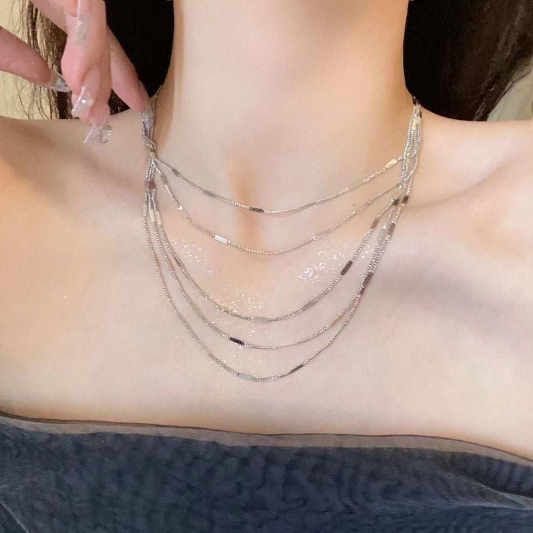 Elegant women's layered silver chain necklace, a delicate fashion accessory perfect for any occasion.