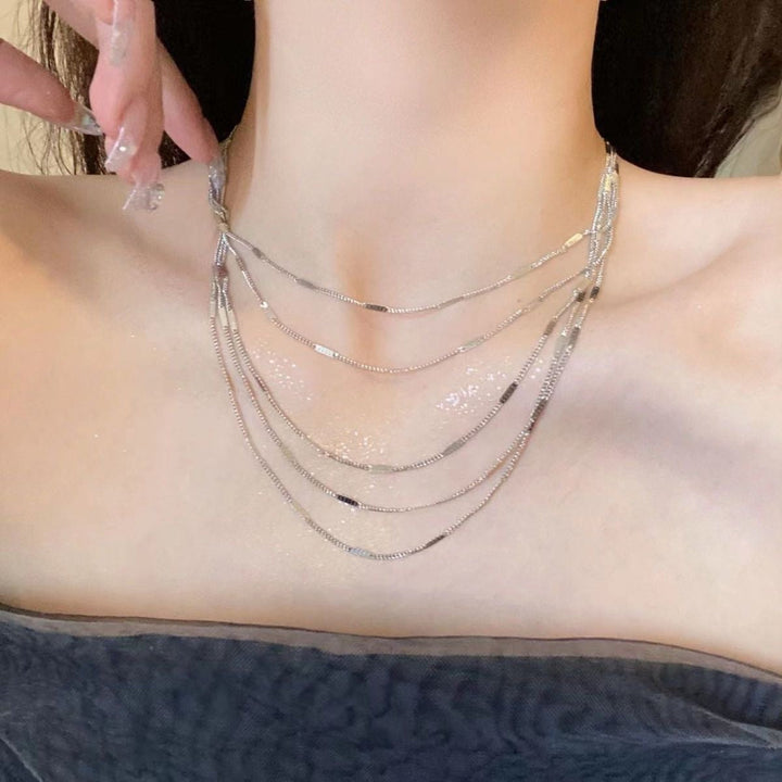 Elegant women's layered silver chain necklace, a delicate fashion accessory perfect for any occasion.