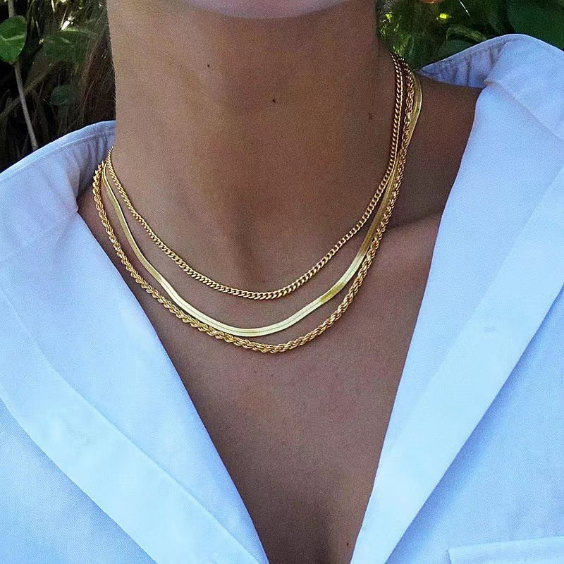 Stylish gold layered chain necklace with unique textured links, a versatile women's jewelry.
