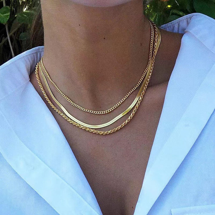 Stylish gold layered chain necklace with unique textured links, a versatile women's jewelry.