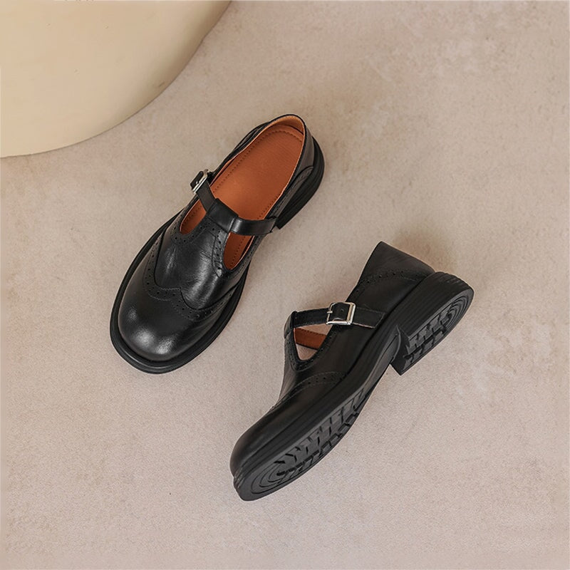 Elegant leather Mary Jane flats for women, vintage style with T-strap and brogue details.