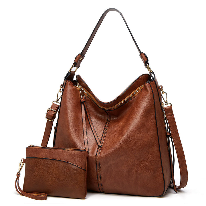 Elegant women's leather shoulder bag with gold details, perfect for daily essentials & versatile style.